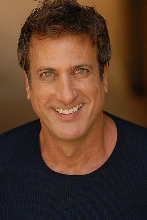 Kristopher Kyer smiling for a professional portrait
