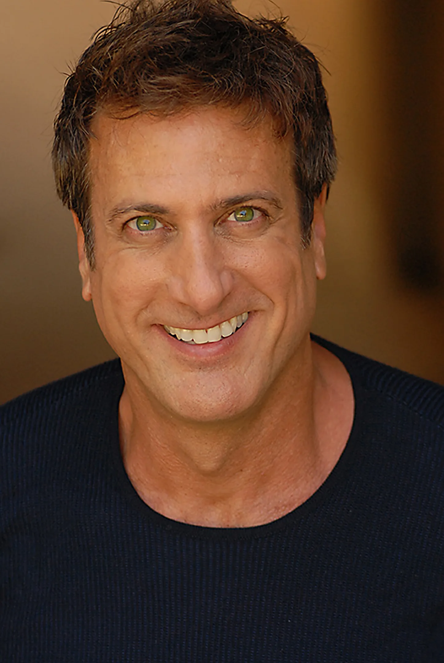Kristopher Kyer smiling in a dark sweater